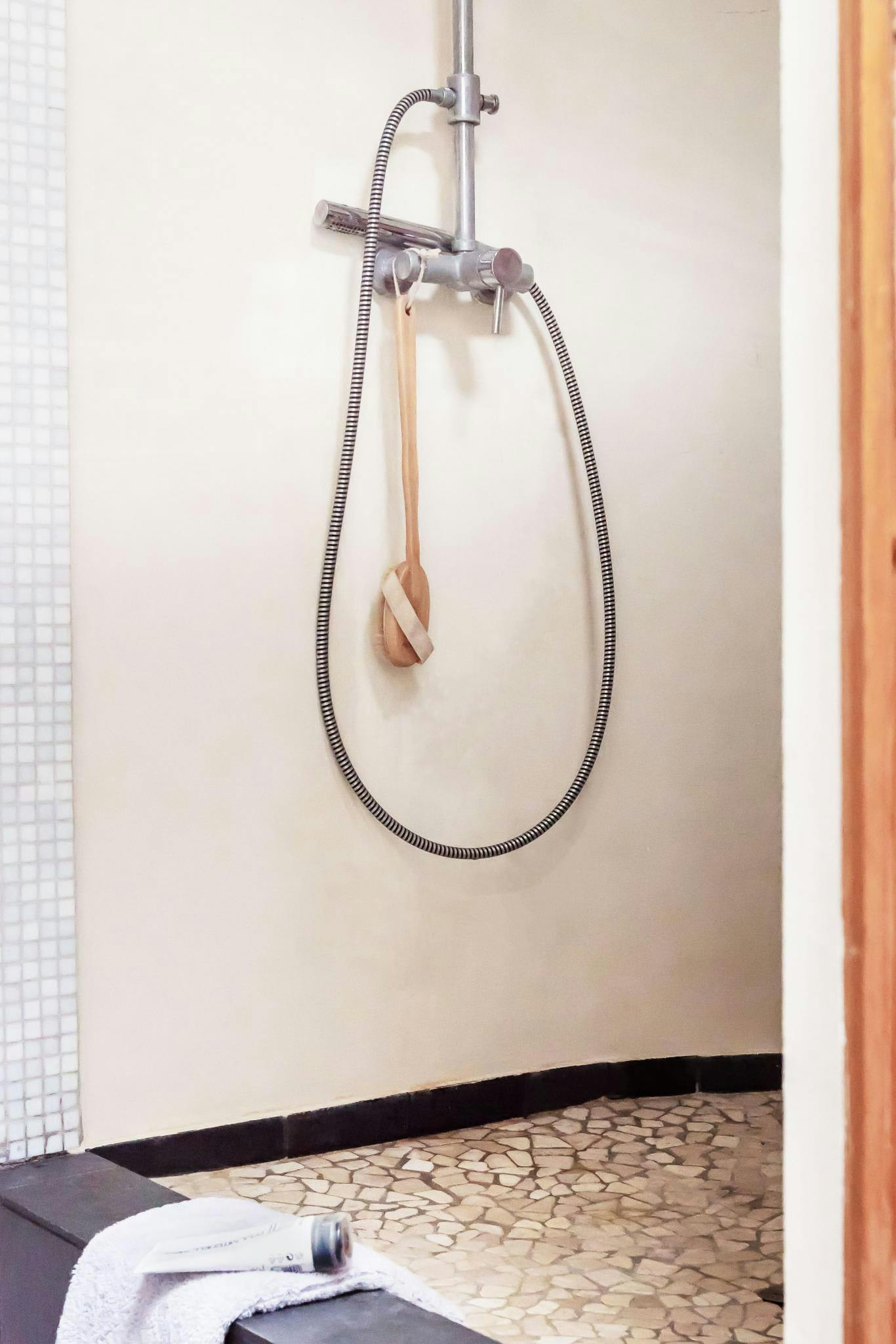 The image features a bathroom with a shower stall, a shower head, and a shower curtain.
