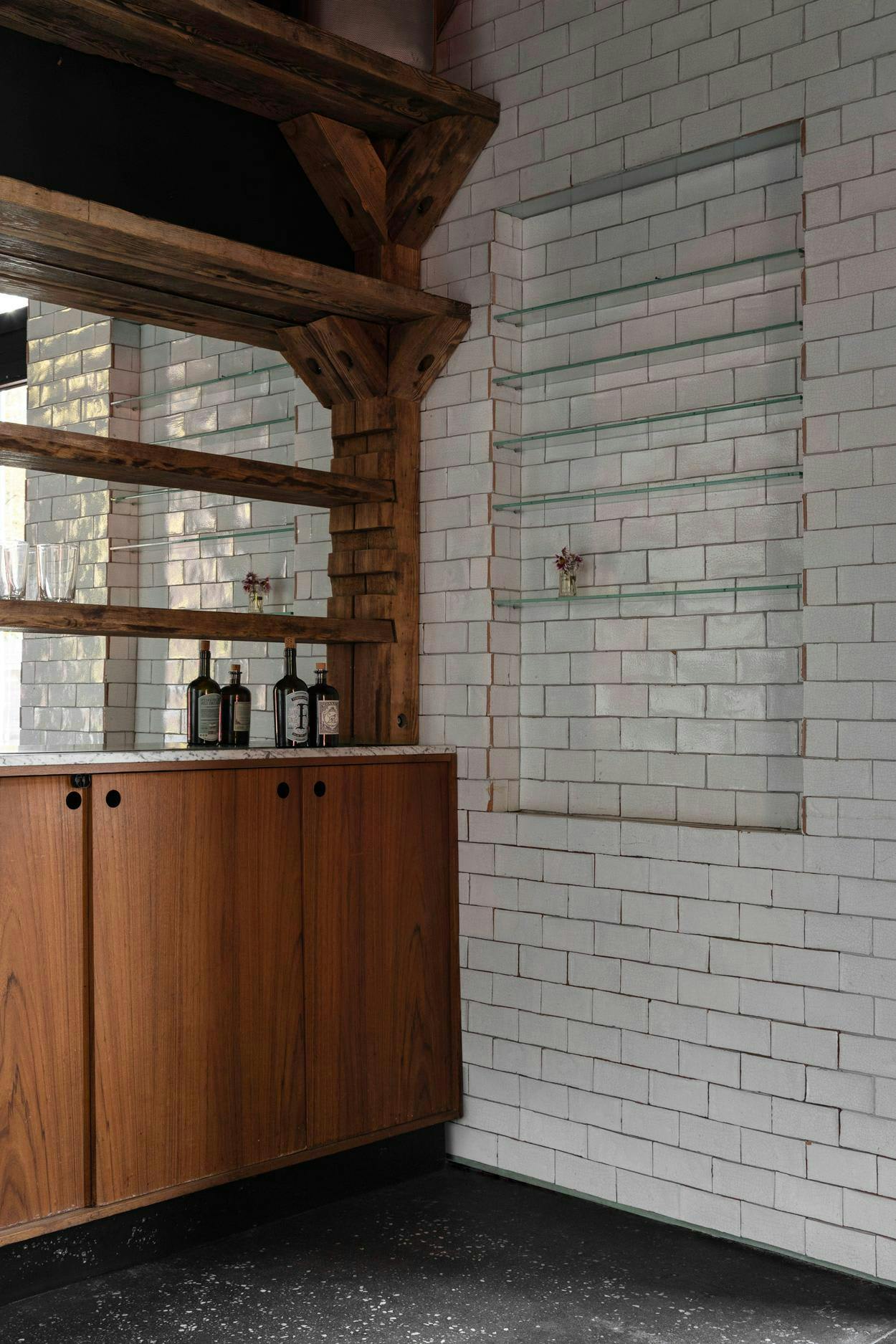 The image features a kitchen with a large window, a wooden cabinet, and a sink.